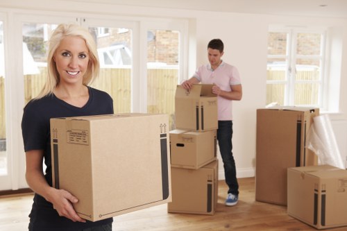 Local movers wrapping fragile belongings for safe transport in Tofrance
