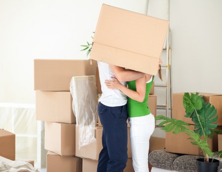 Professional movers handling furniture and packed boxes during a Tofrance relocation