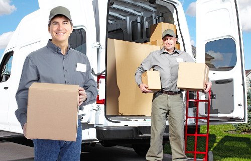 Moving crew handling office furniture and storage items in Tofrance