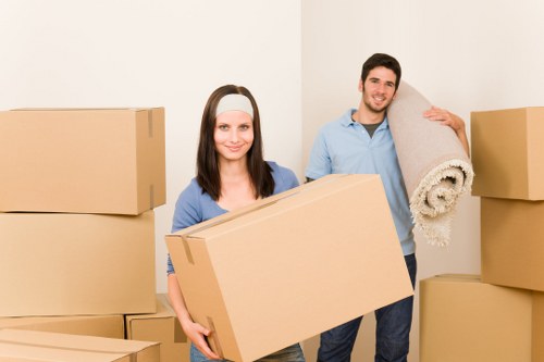 Movers carrying furniture through a narrow staircase in a Tofrance property